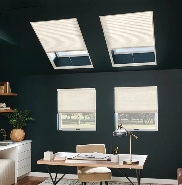 White cellular shades on skylights in a teal home office