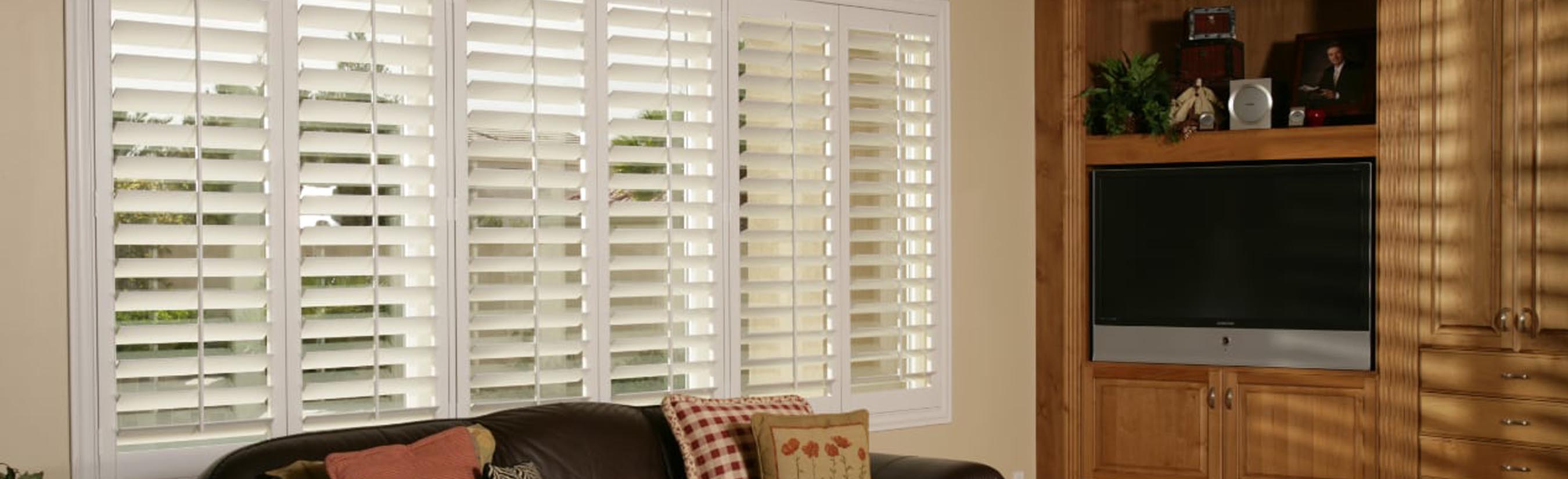 White plantation shutters in a living room.