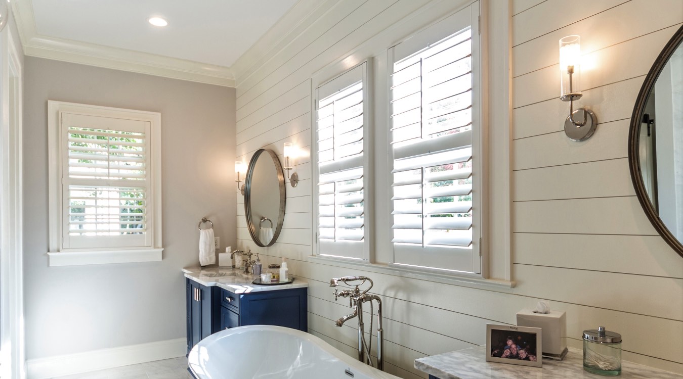 New York City bathroom with white plantation shutters.