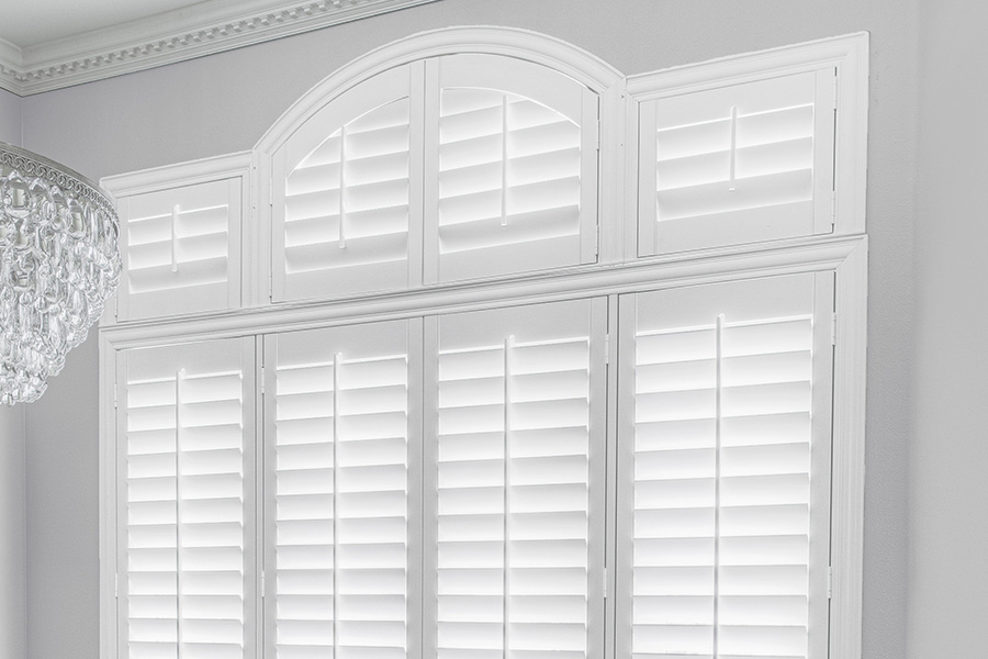 Customize your Palladian windows with white Polywood shutters in New York. White Polywood Palladian windows in a dining room.