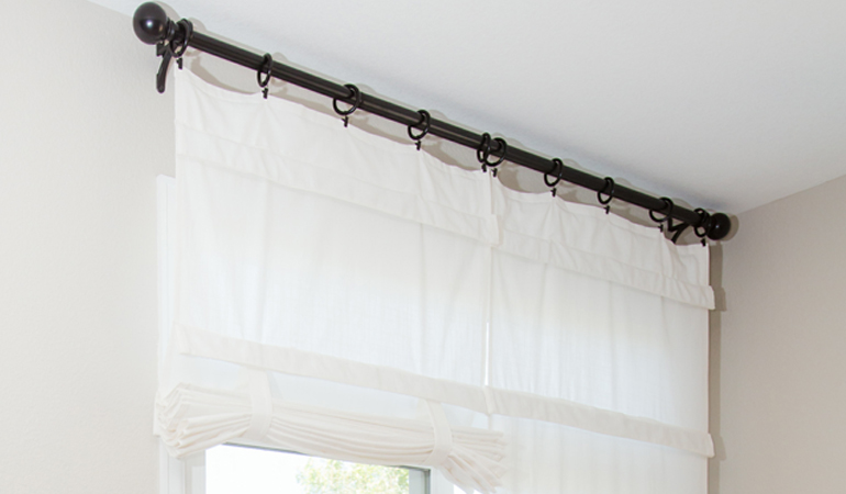 Tumble shades in New York give your doors privacy versatility and style. White tumble shade on double glass doors