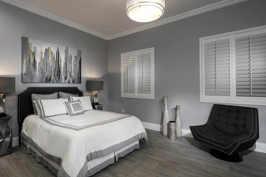 Close your custom Polywood shutters to beat the heat and keep your New York bedroom cool. White Polywood shutters on bedroom windows