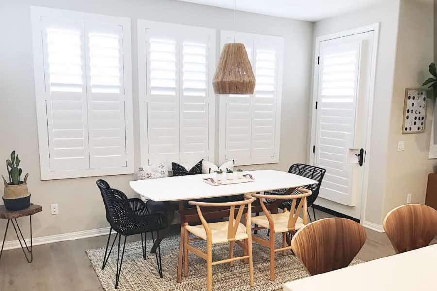 Use Polywood shutters to control natural light levels in your New York dining room. Polywood shutters with top louvers tilted open in a dining room