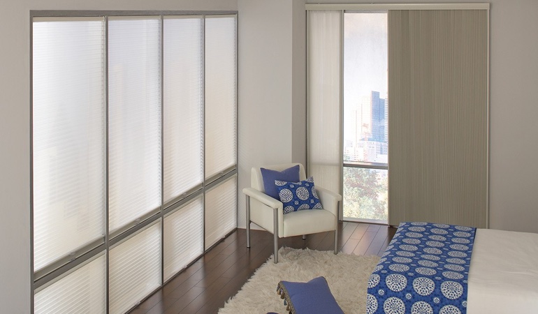 Cellular shades are another choice to achieve your minimalist design. Cellular shades in a modern bedroom.