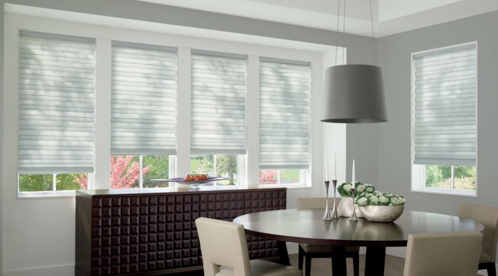 Custom cordless roller shades have a clean look and are appropriate for any room. Cordless motorized shades in a New York dining room