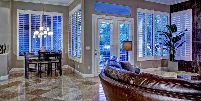Photo Courtesy of Room Resolutions New York great room with classic shutters and leather furniture.