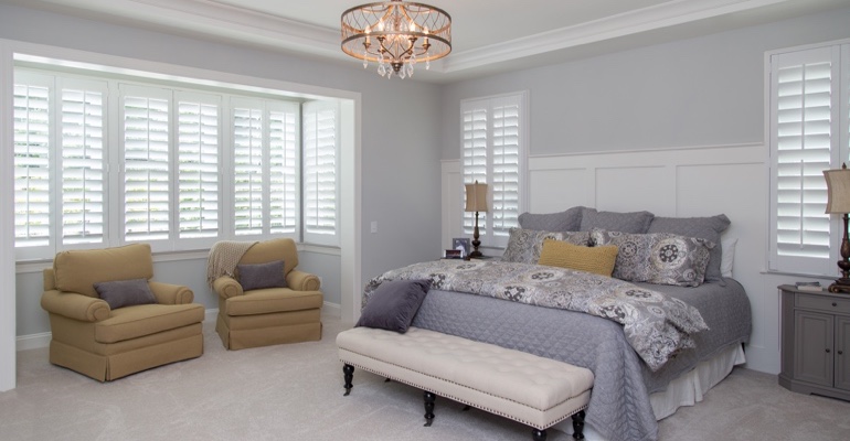 interior shutters offer subtle fashion. White shutters in New York bedroom.