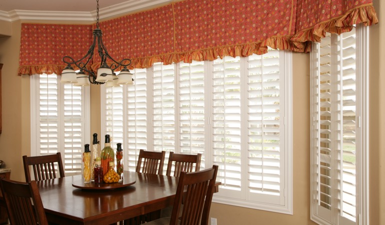 Decorative accents, drapes, and curtains may not provide the simplicity you want. White shutters in New York dining room.