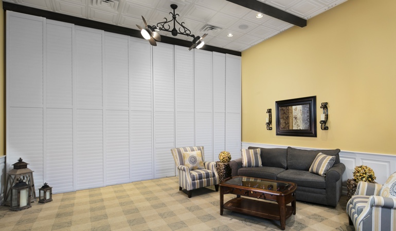 Shutters can be used on as a room divider. Interior shutters as a room divider for a business