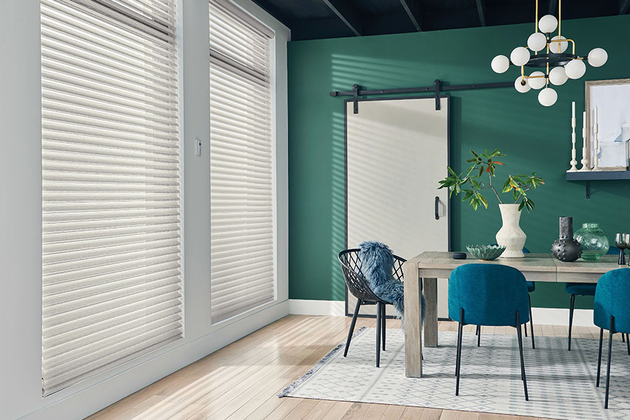 Versatile sheer shades let you decide how much of a view you want while enjoying your New York dining room. White sheer shades on windows in a green dining room