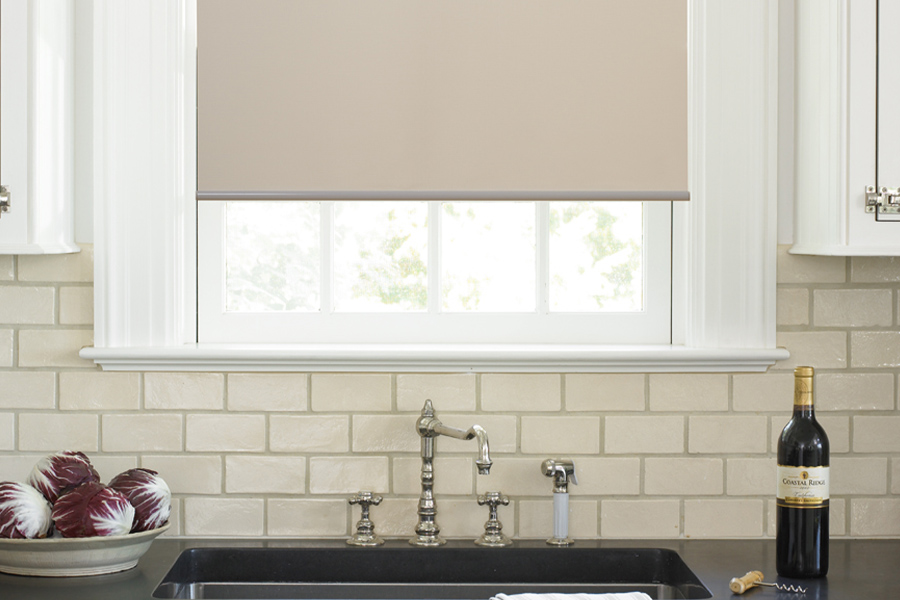Roller shades opens up a lot of color and style options for your gourmet kitchen at New York. Roller shade above a kitchen sink.