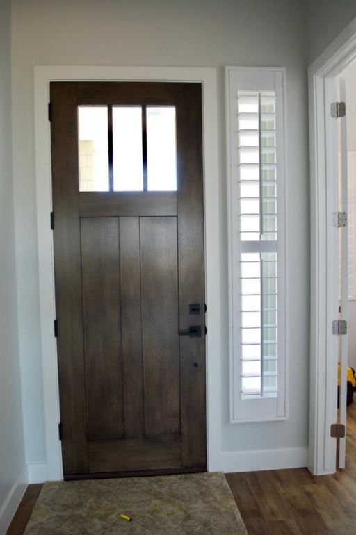 Sidelights give your entryway a view of outside while helping maintain privacy. Plantation shutters on a front door