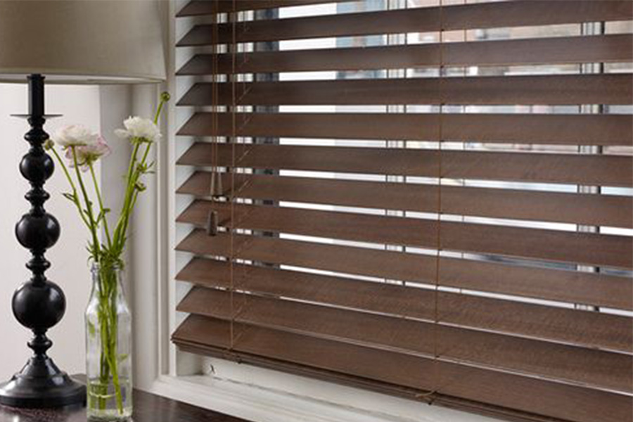 Wood blinds are offered in many styles and customizations. up close shot of dark wooden blinds